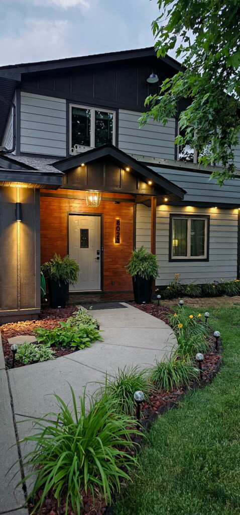 Twilight real estate photo of a modern craftsman home exterior at dusk